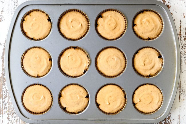 process shot showing how to make mini pumpkin cheesecakes by adding cheesecake to muffin tins