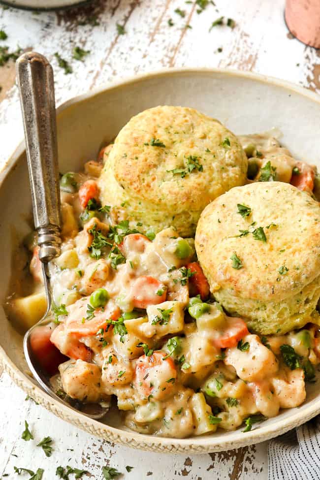 a bowl of chicken pot pie recipe with two biscuits