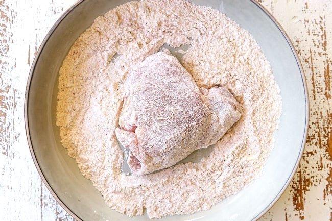 showing how to make chicken cacciatore recipe by dredging chicken in flour
