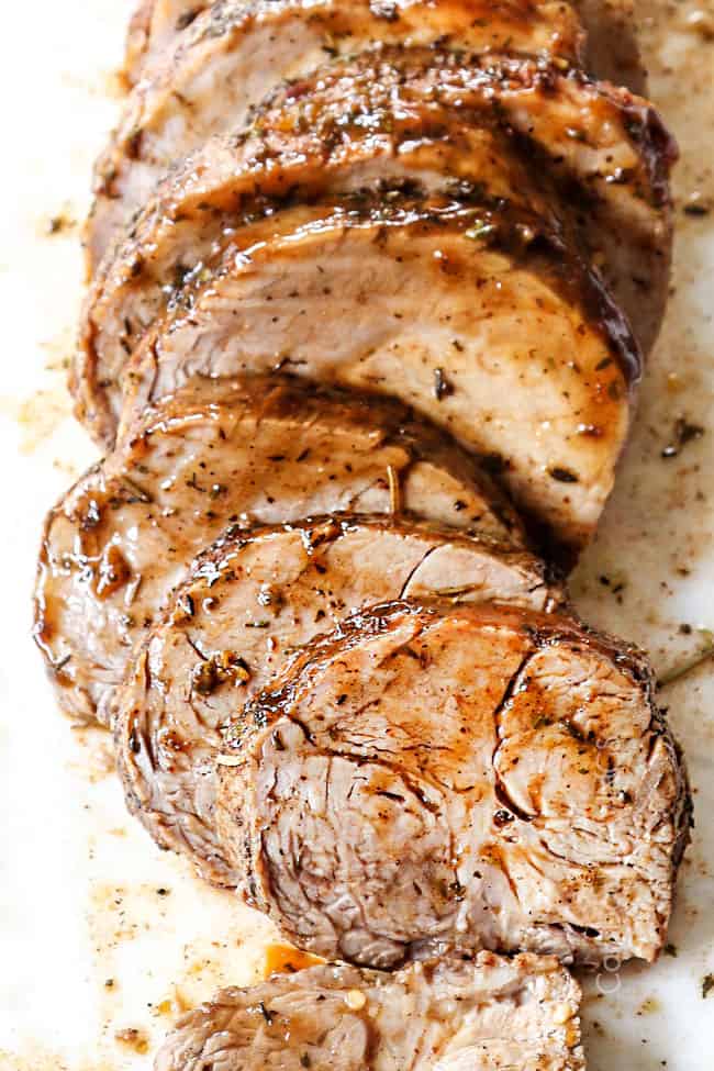 up close of slices of slow cooker pork loin roast showing how juicy it is