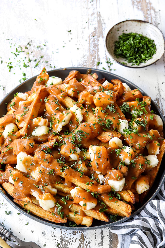 poutine recipe on a plate garnished with parsley