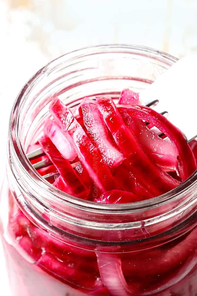 up close of pickled red onion recipe in a glass jar