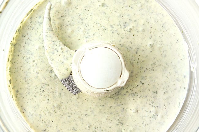 showing how to make rice bowl by making cilantro yogurt sauce in food processor