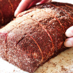 showing how to cook beef tenderloin recipe by seasoning beef on all sides with kosher salt and seasoning rub