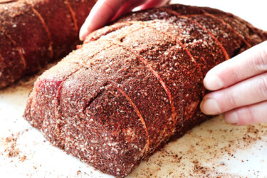 showing how to cook beef tenderloin recipe by seasoning beef on all sides with kosher salt and seasoning rub