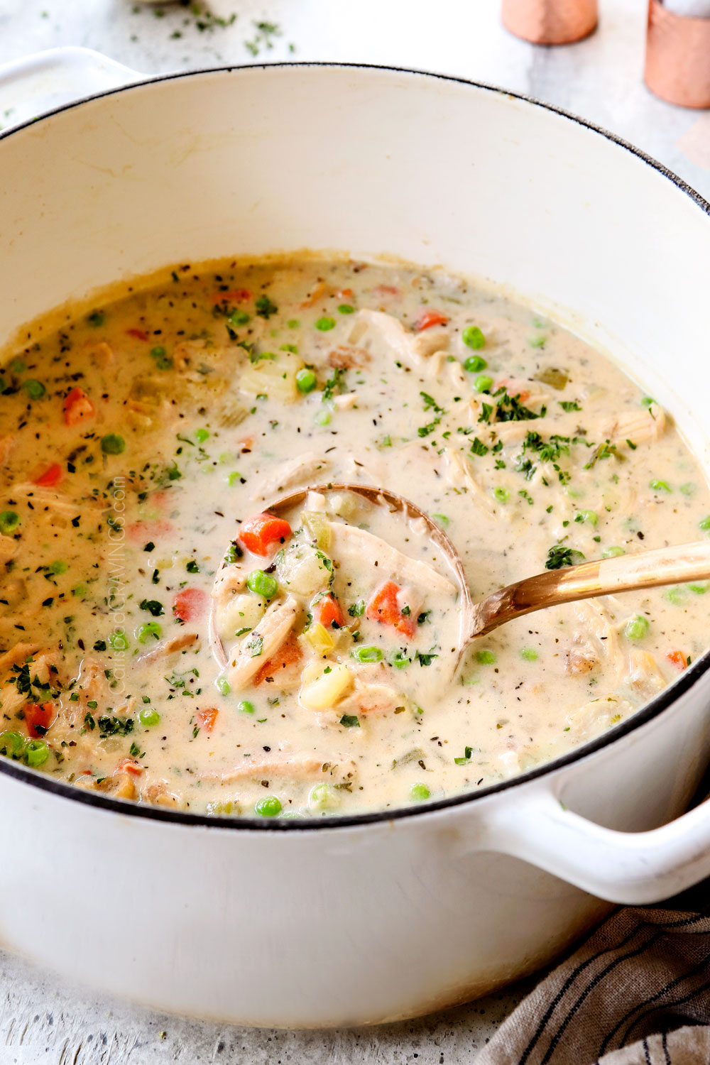 scooping up chicken pot pie soup recipe showing how creamy it is