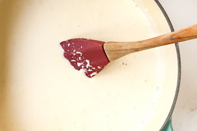 showing how to make creme brulee by heating heavy cream in a saucepan