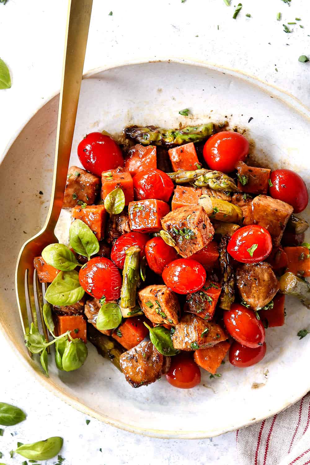 balsamic chicken on a plate with tomatoes and vegetables