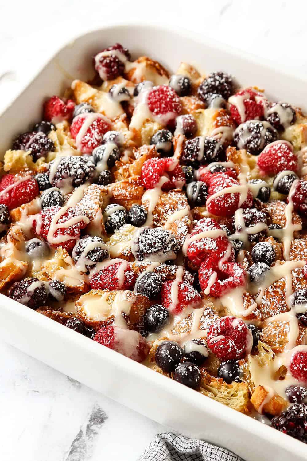 side view of overnight croissant breakfast casserole with berries