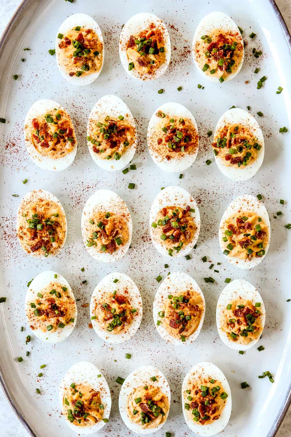 top view of deviled eggs recipe on a platter garnished with paprika