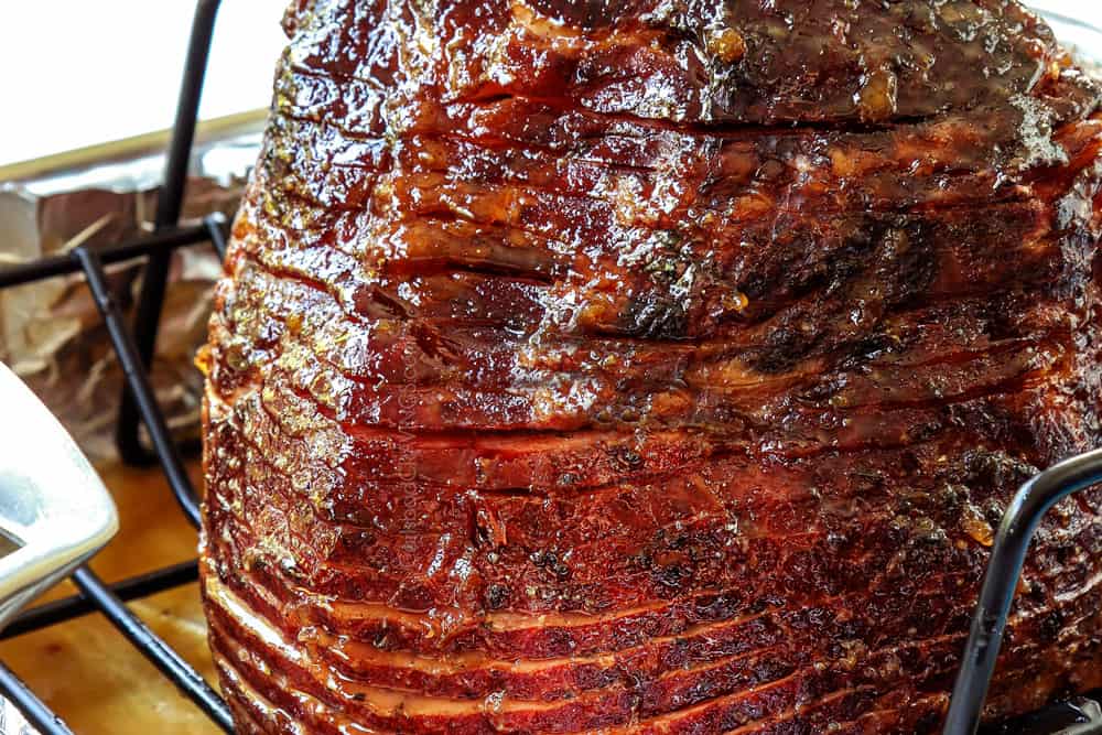 showing how to make spiral ham by brushing ham with brown sugar pineapple ham glaze
