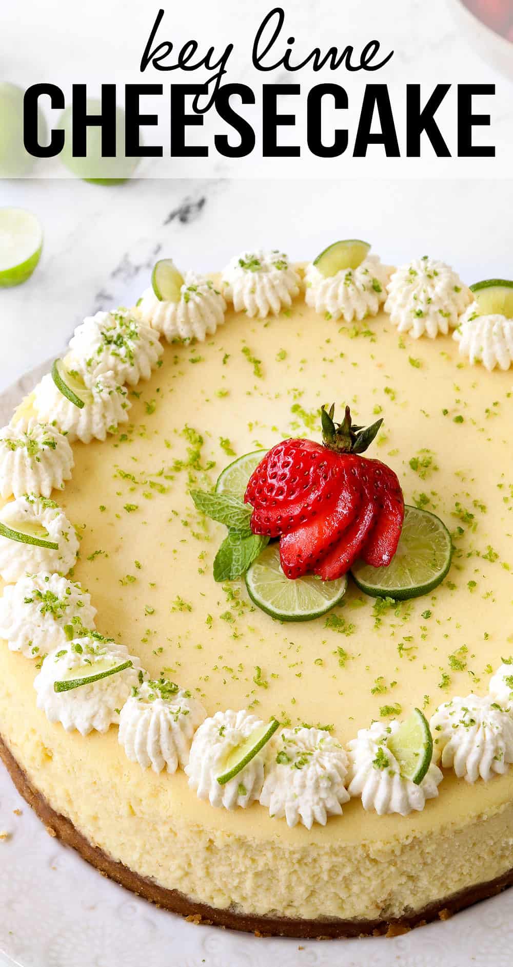 key lime cheesecake garnished with whipped cream, key limes and strawberries