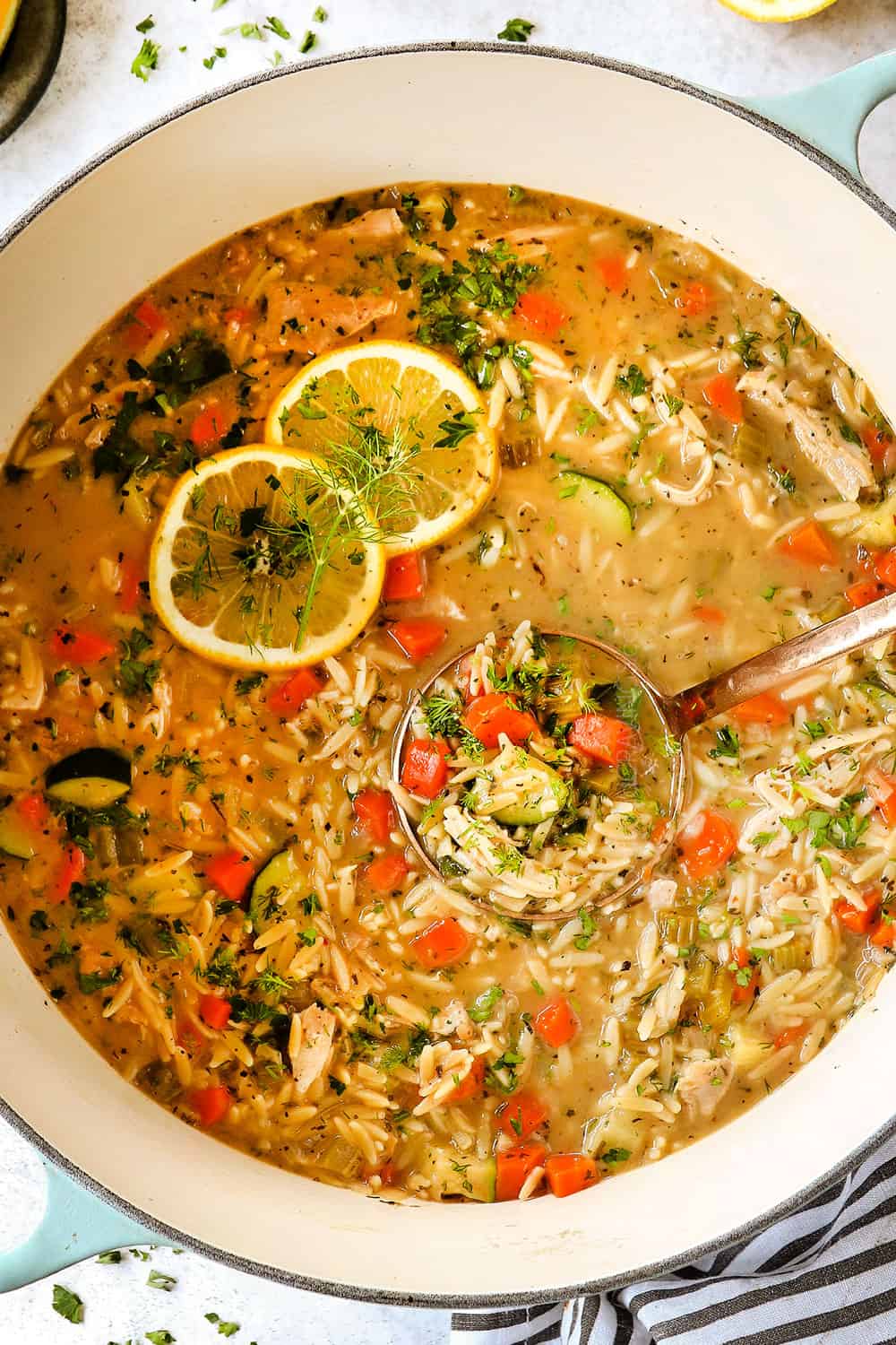 top view of easy, healthy lemon chicken orzo soup in a Dutch oven