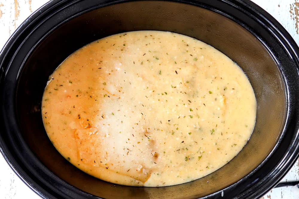 showing how to make crockpot chicken and gravy by pouring gravy over chicken in crockpot and cooking until tender