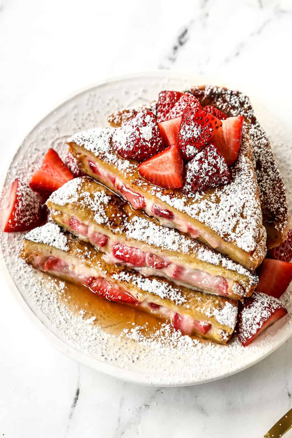 stuffed French Toast with cream cheese and strawberries on a white plate