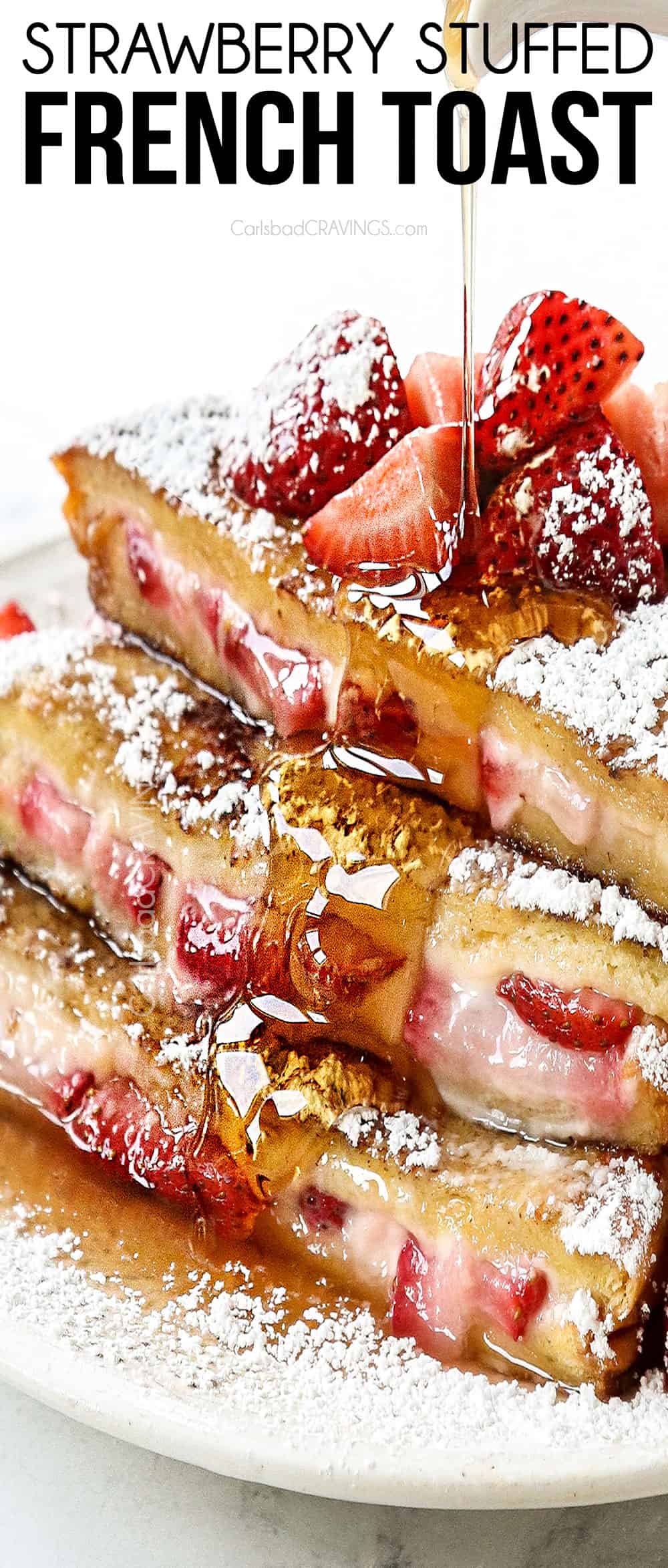 stuffed French Toast stacked on a white plate being drizzled with syrup