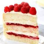 a slice of white chocolate raspberry cake on a plate