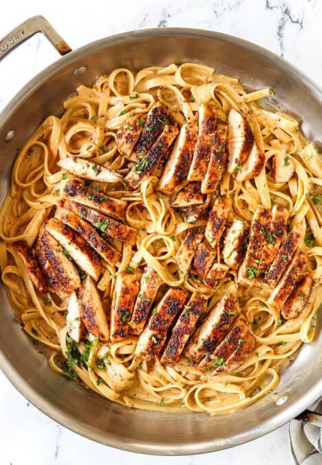 top view of Blackened Chicken Alfredo in a stainless steel skillet