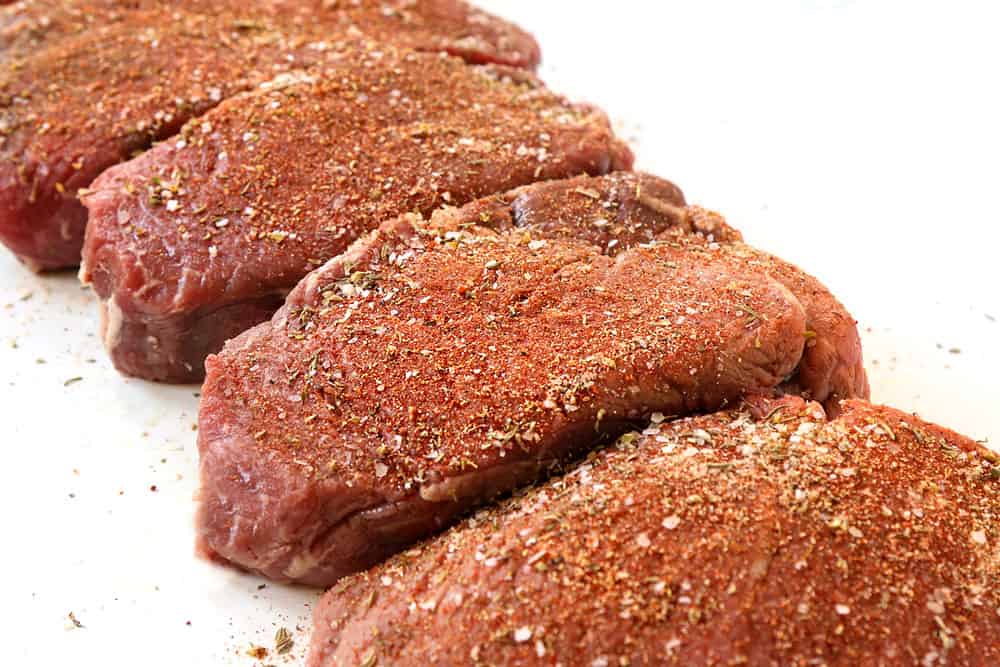 showing how to grill steak by seasoning with a spice rub and letting the steaks rest