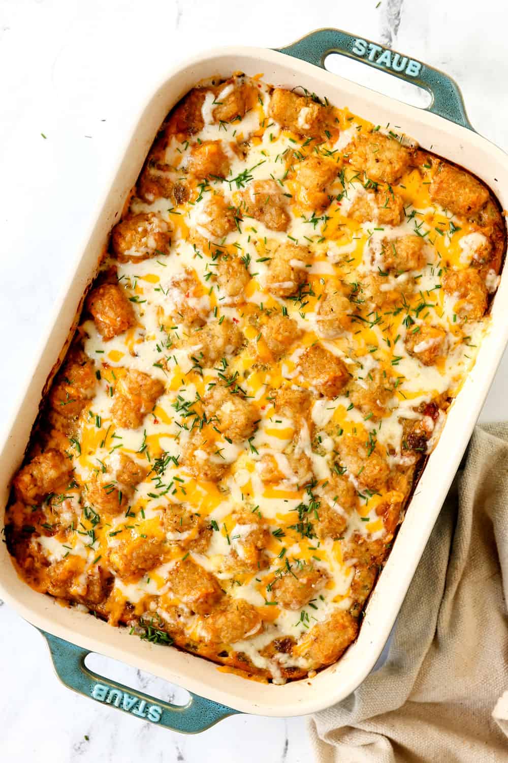 top view of tater tot casserole in a 9x13 baking dish