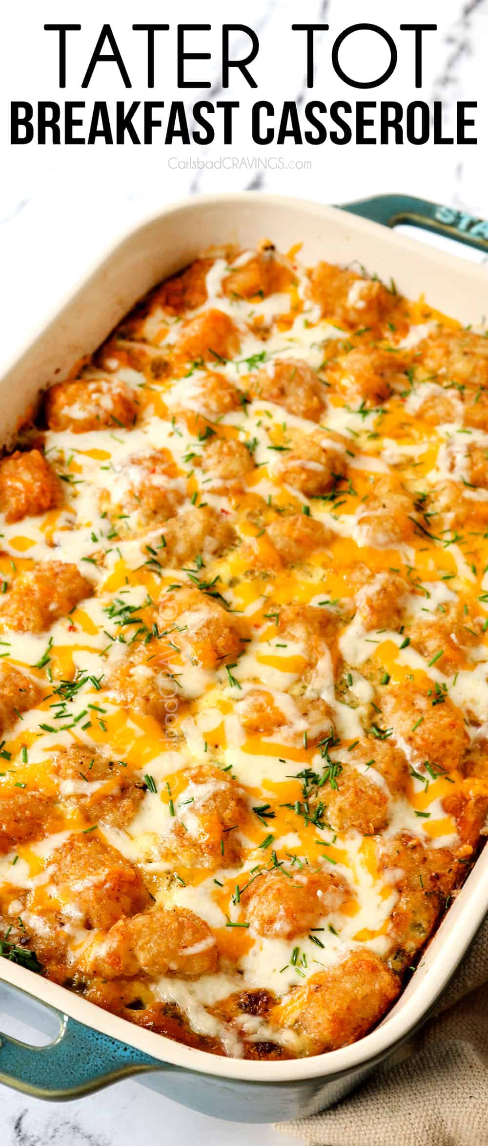 tater tot breakfast casserole covered with cheese and crispy tater tots