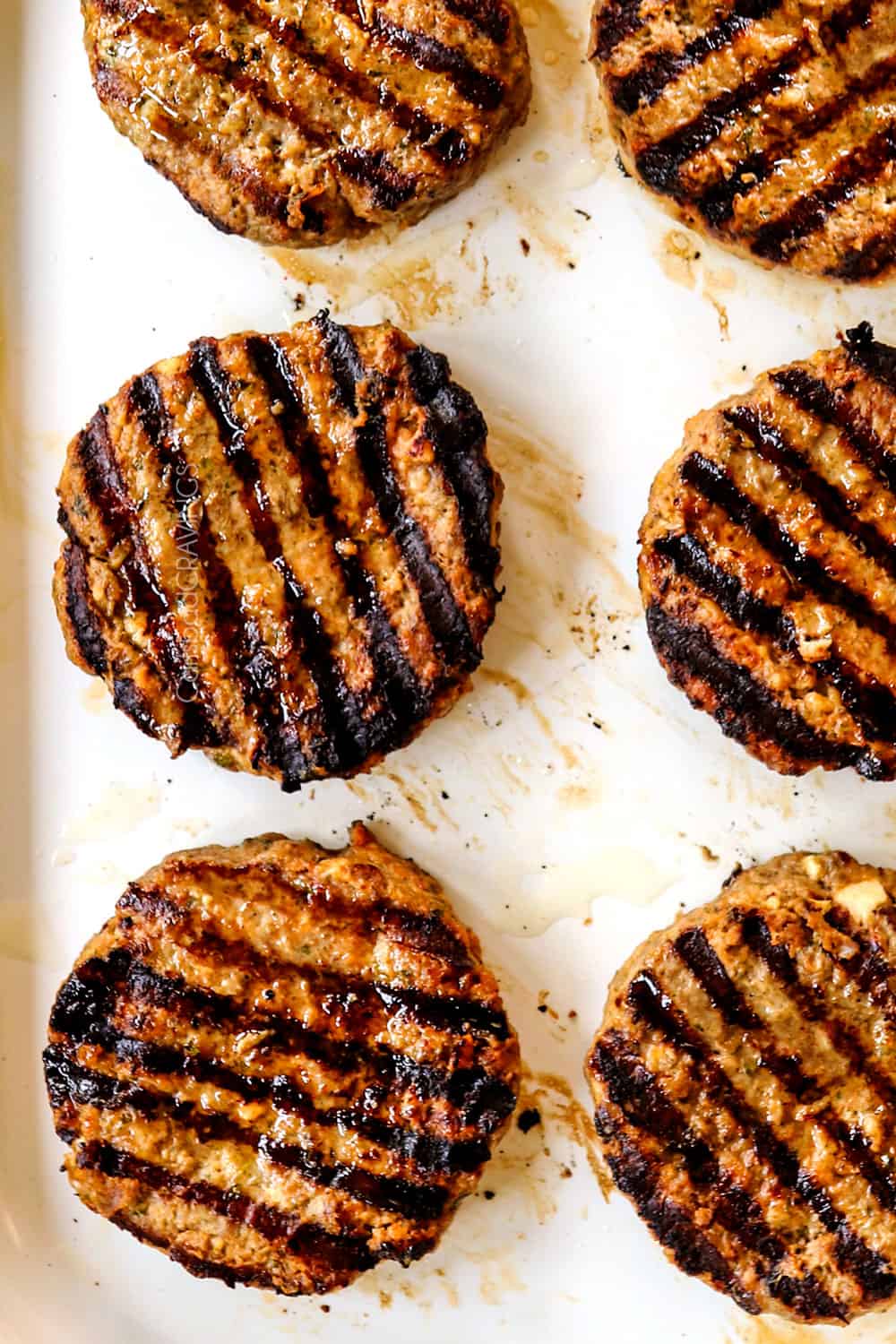 showing how to make Greek burgers with lamb by grilling until there are dark grill marks