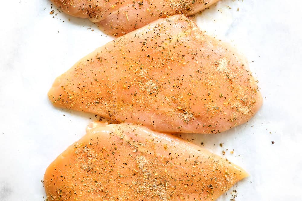 showing how to make chicken Caprese recipe by seasoning chicken breasts with Italian seasonings