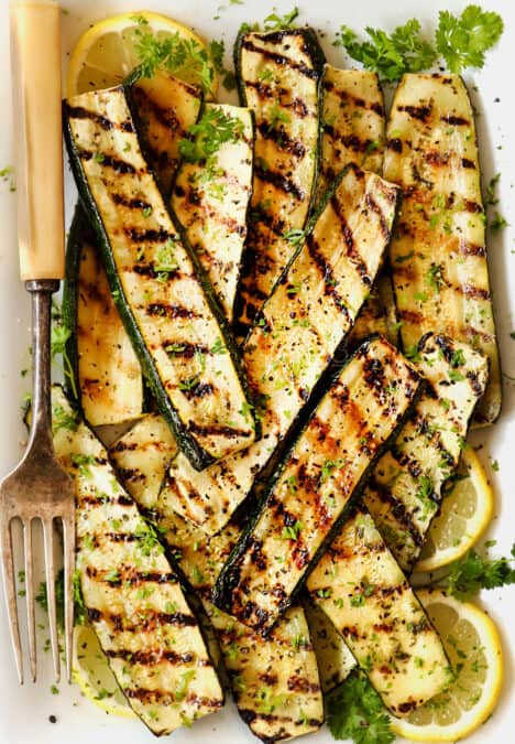 top view of grilled zucchini on a white platter