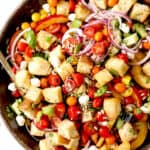 top view of Panzanella in a wood bowl with tomatoes, bread and onions