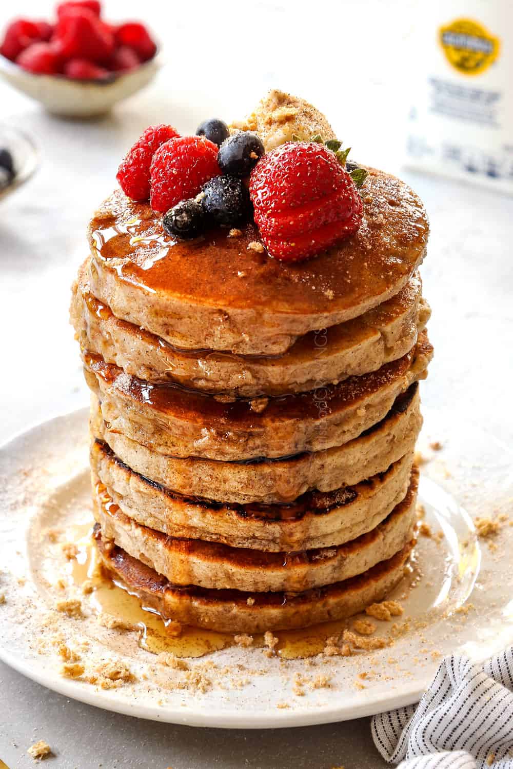 front view of cereal pancakes with berries and syrup