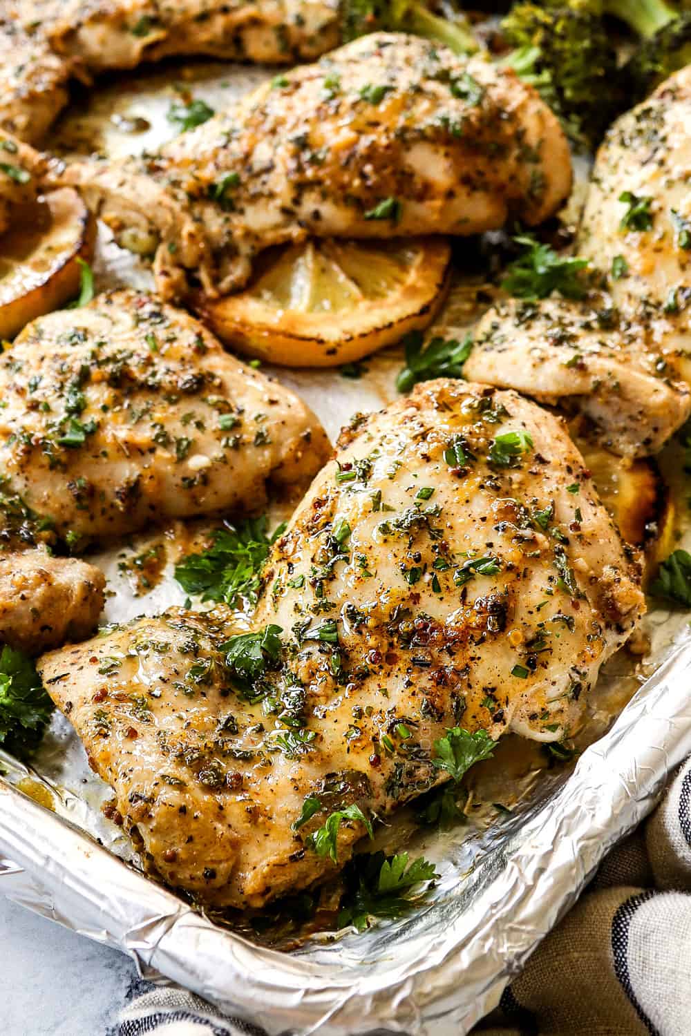 up close of lemon garlic chicken thighs showing how juicy they are
