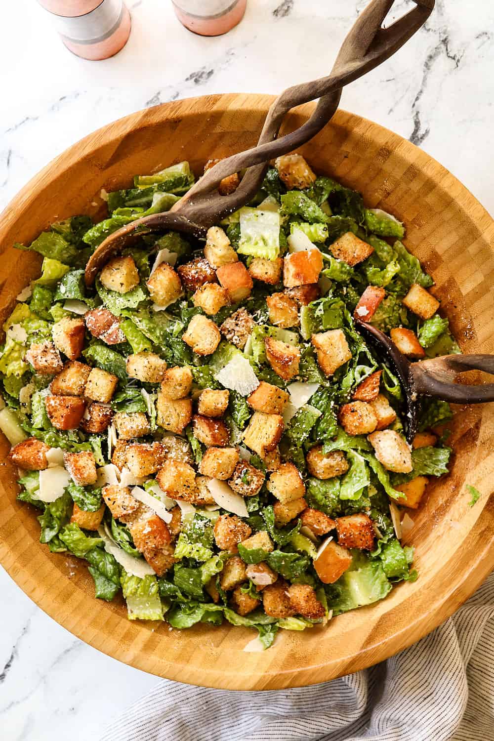 showing how to use Caesar Salad Dressing by adding to a salad
