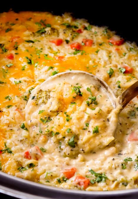 showing how to serve creamy, cheesy crockpot chicken and rice by garnishing it with parsley