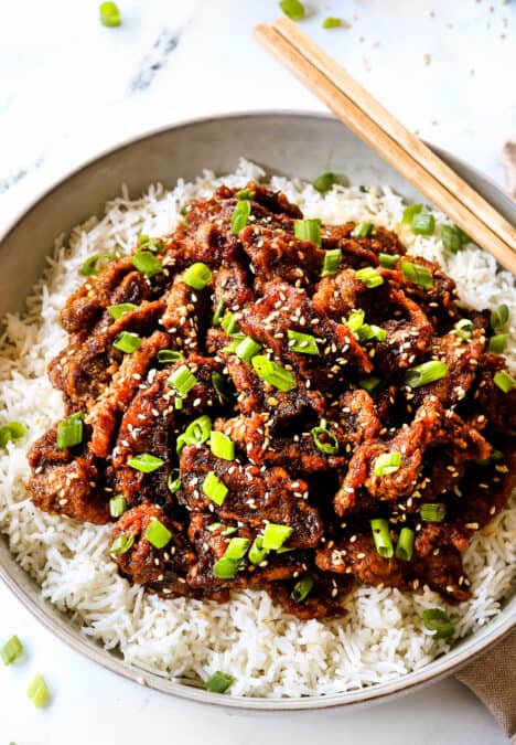 up close of Chinese ginger beef over rice showing how crispy the beef is
