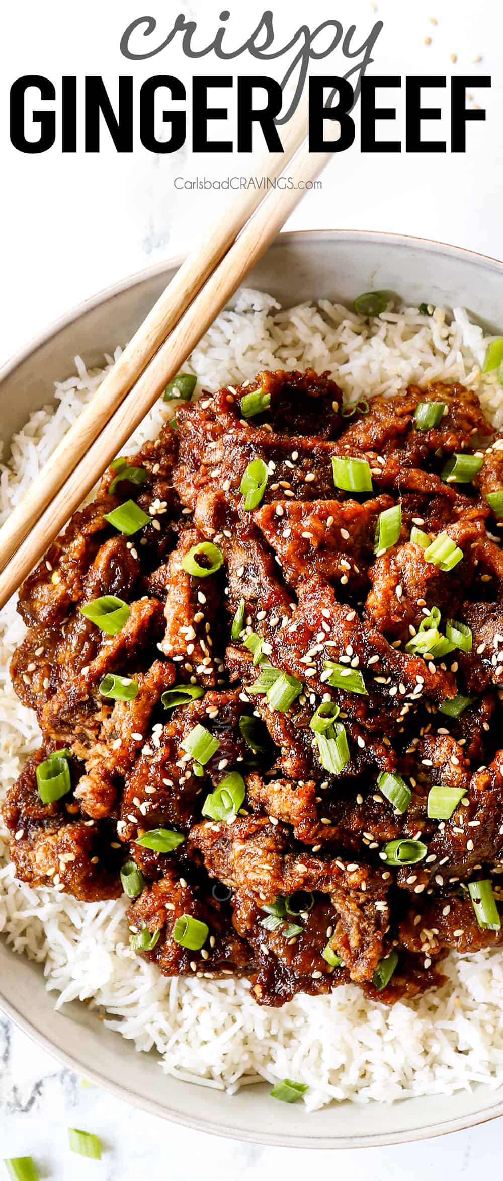 top view of ginger beef in a white bowl on top of rice