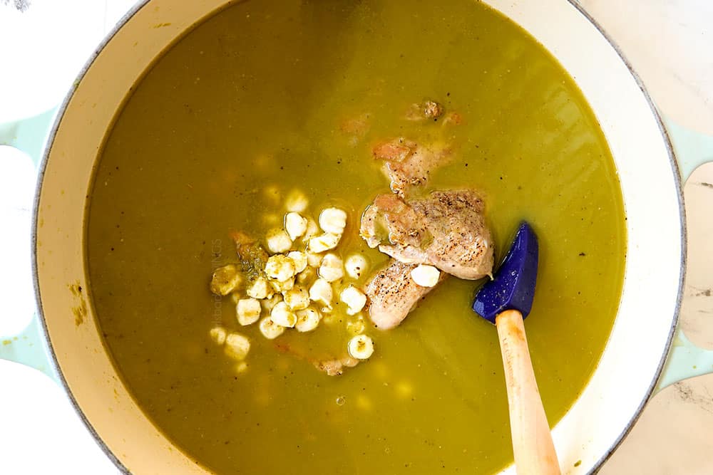 showing how to make pozole verde (posole) by adding seared chicken and hominy to the salsa verde to simmer