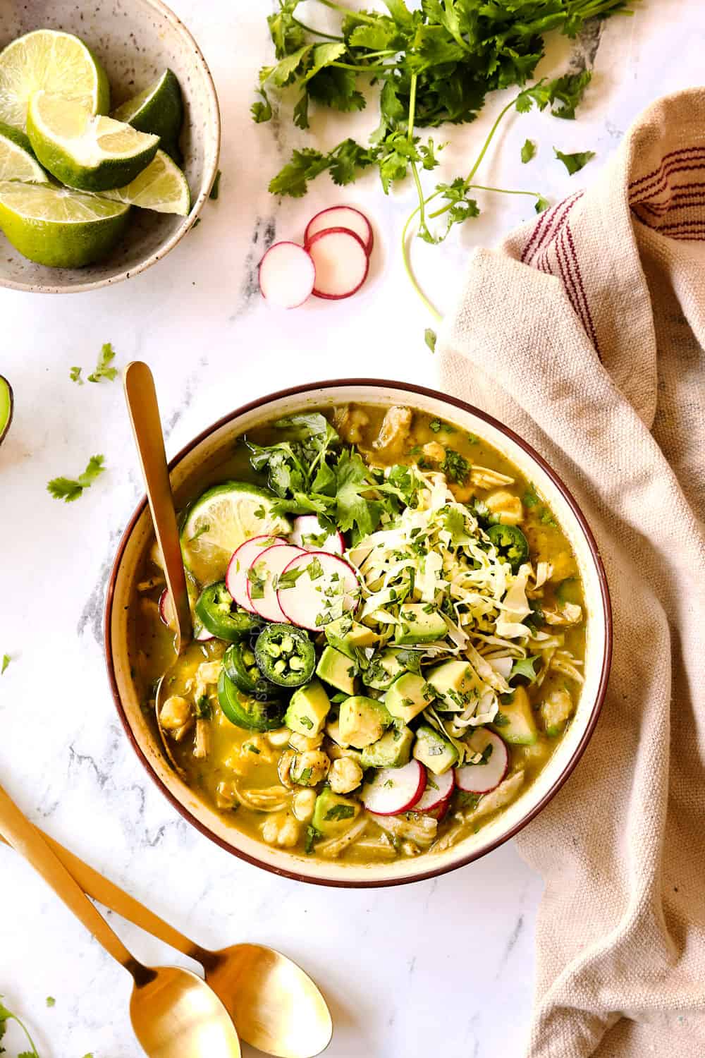 showing how to make pozole verde with chicken (chicken posole) by topping it with radishes, cabbage, jalapenos and cilantro