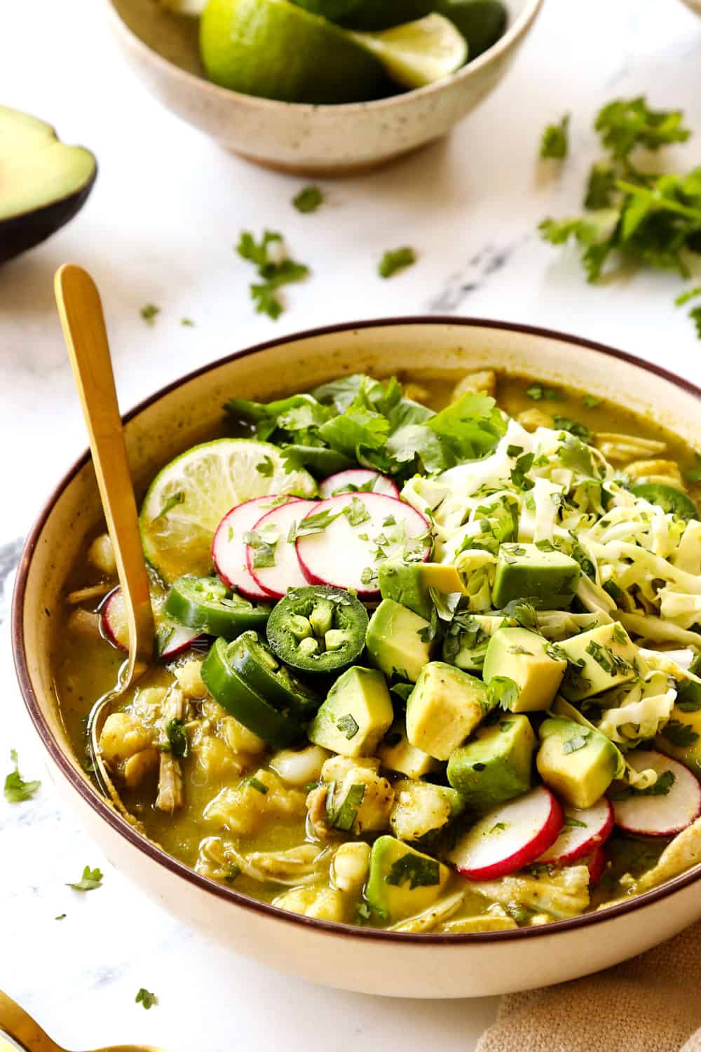 a bowl of pozole verde recipe (posole) with chicken, hominy and salsa verde