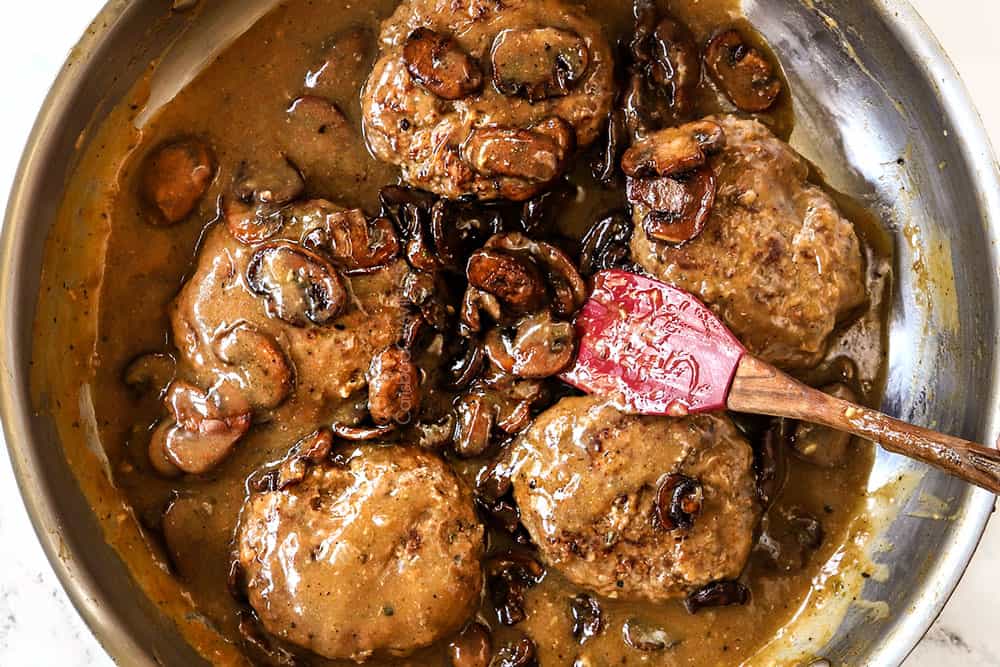 showing how to make Salisbury Steaks by adding mushrooms to the skillet with beef patties