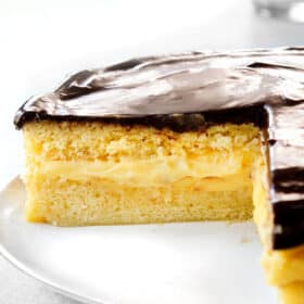 up close of Boston Cream Pie with a slice taken out of it