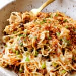 up close of Turkey Tetrazzini recipe in a bowl with a fork showing how to serve