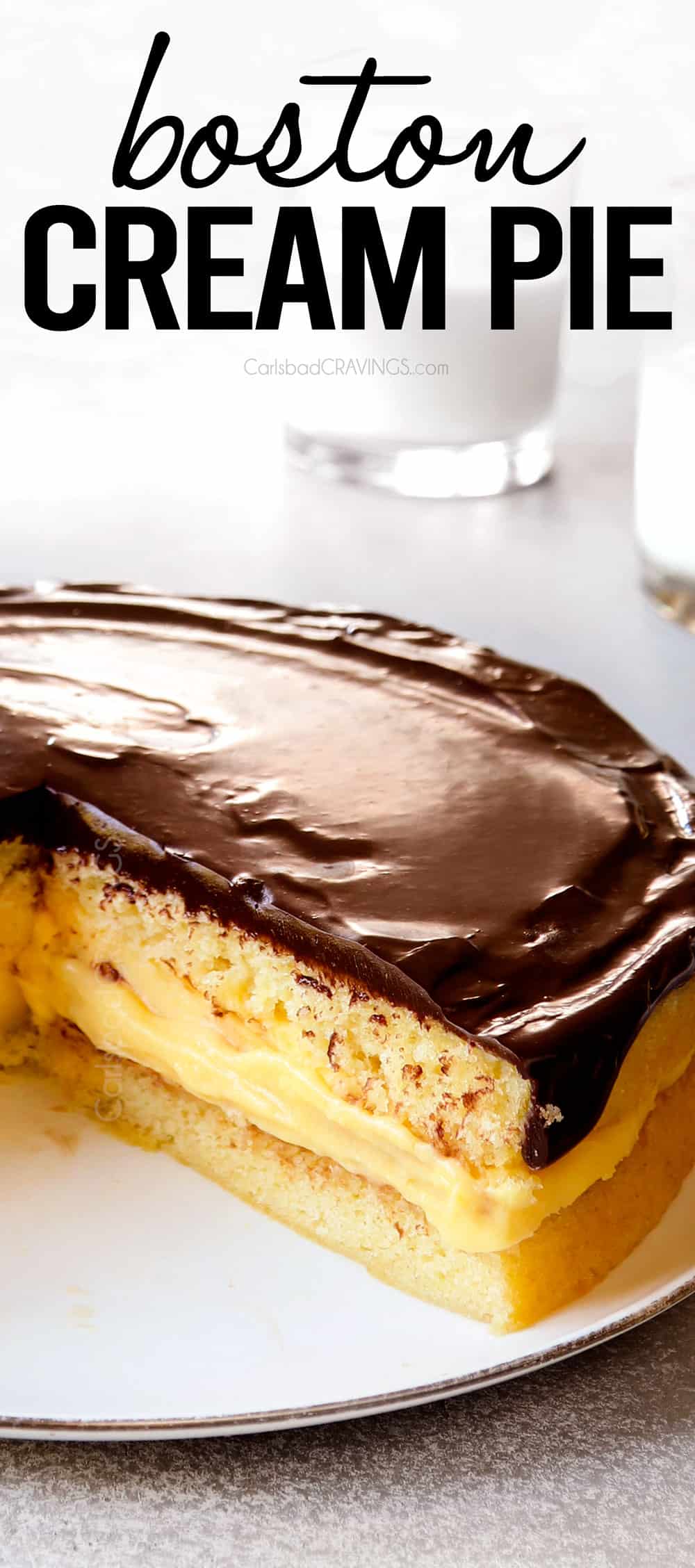 up close of Boston Cream Pie with slices missing showing how fluffy the cake is