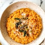 top view of pumpkin risotto in a bowl with freshly grated parmesan