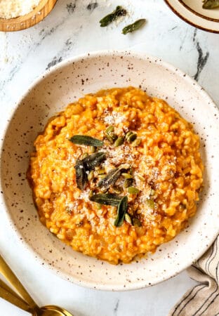 top view of pumpkin risotto in a bowl with freshly grated parmesan