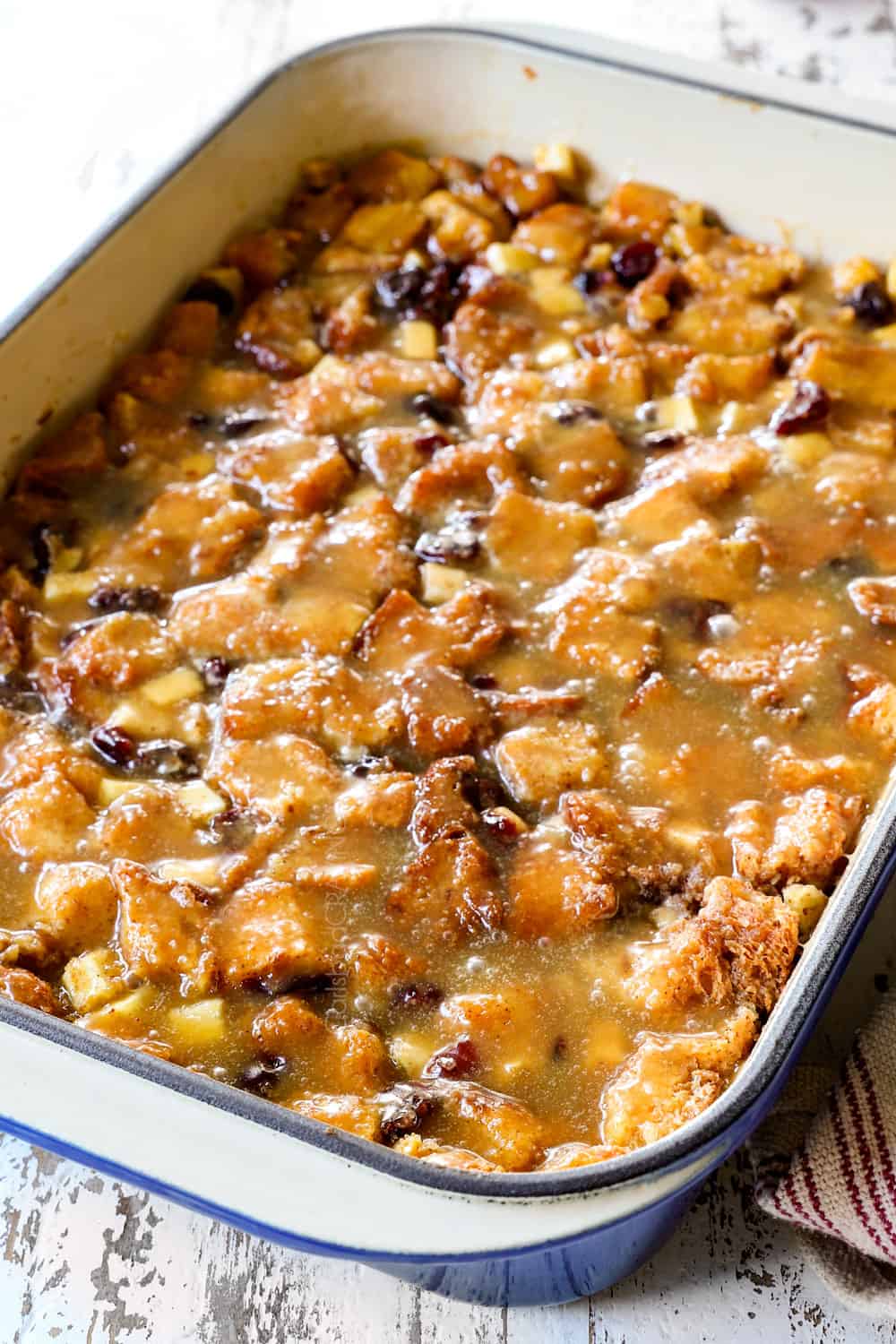 side view of best bread pudding recipe with apples and caramel sauce