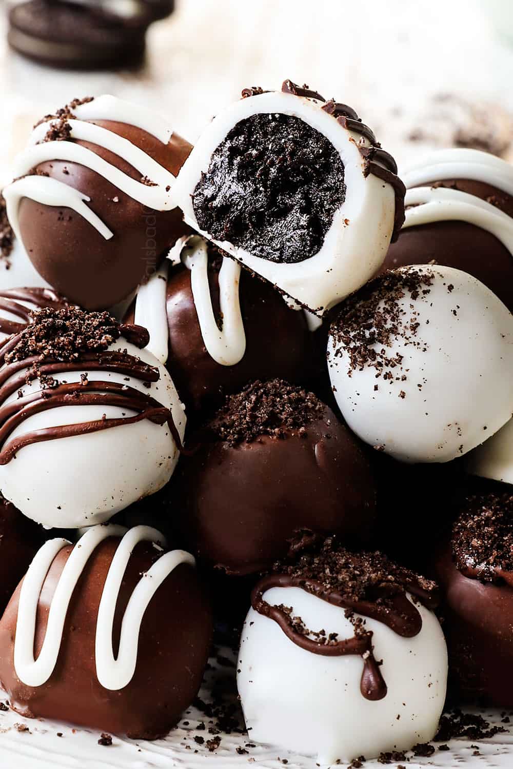 a stack of Oreo truffles on a plate showing how shiny they are