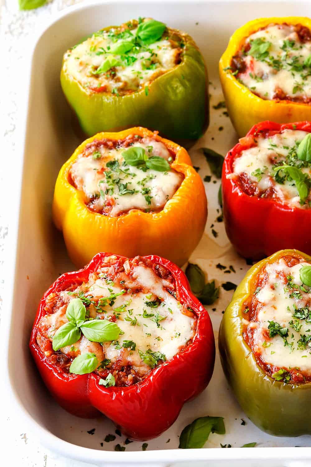 showing how to make stuffed peppers by baking peppers until tender and the cheese is melted