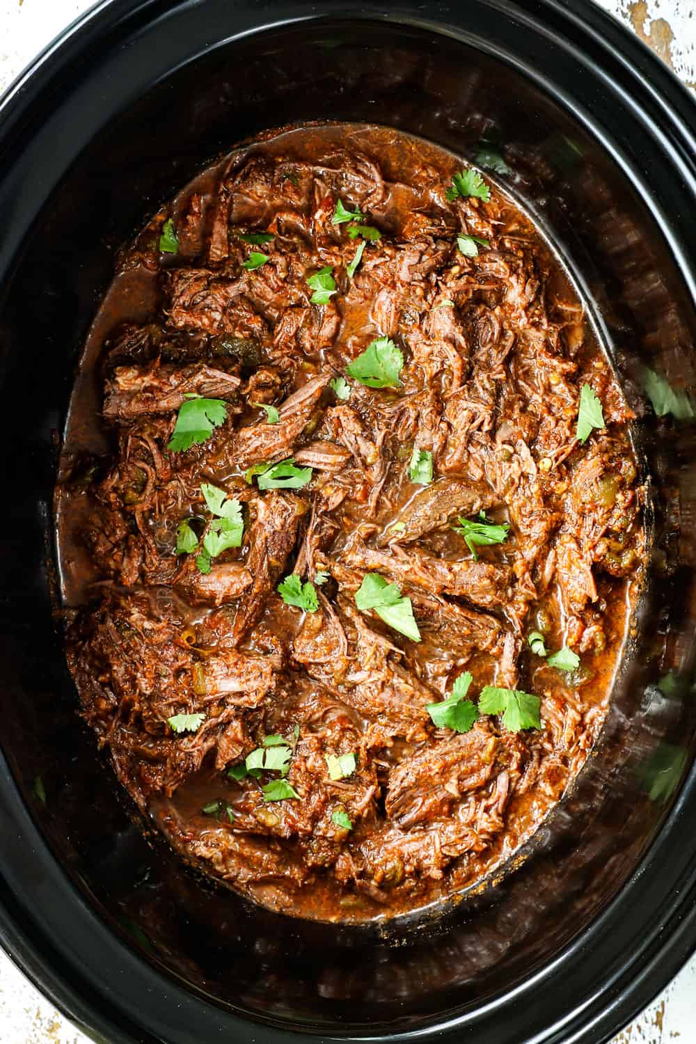 top view showing how to make Mexican shredded beef by soaking in braising liquid