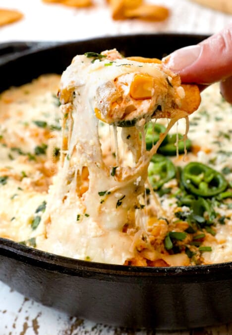 a cheesy pull of Mexican Street Corn Dip showing how cheesy it is