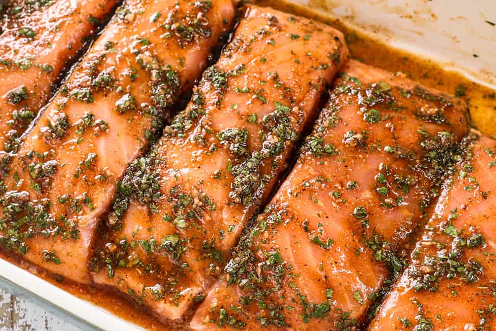 showing how to make baked salmon by marinating salmon in cilantro lime marinade